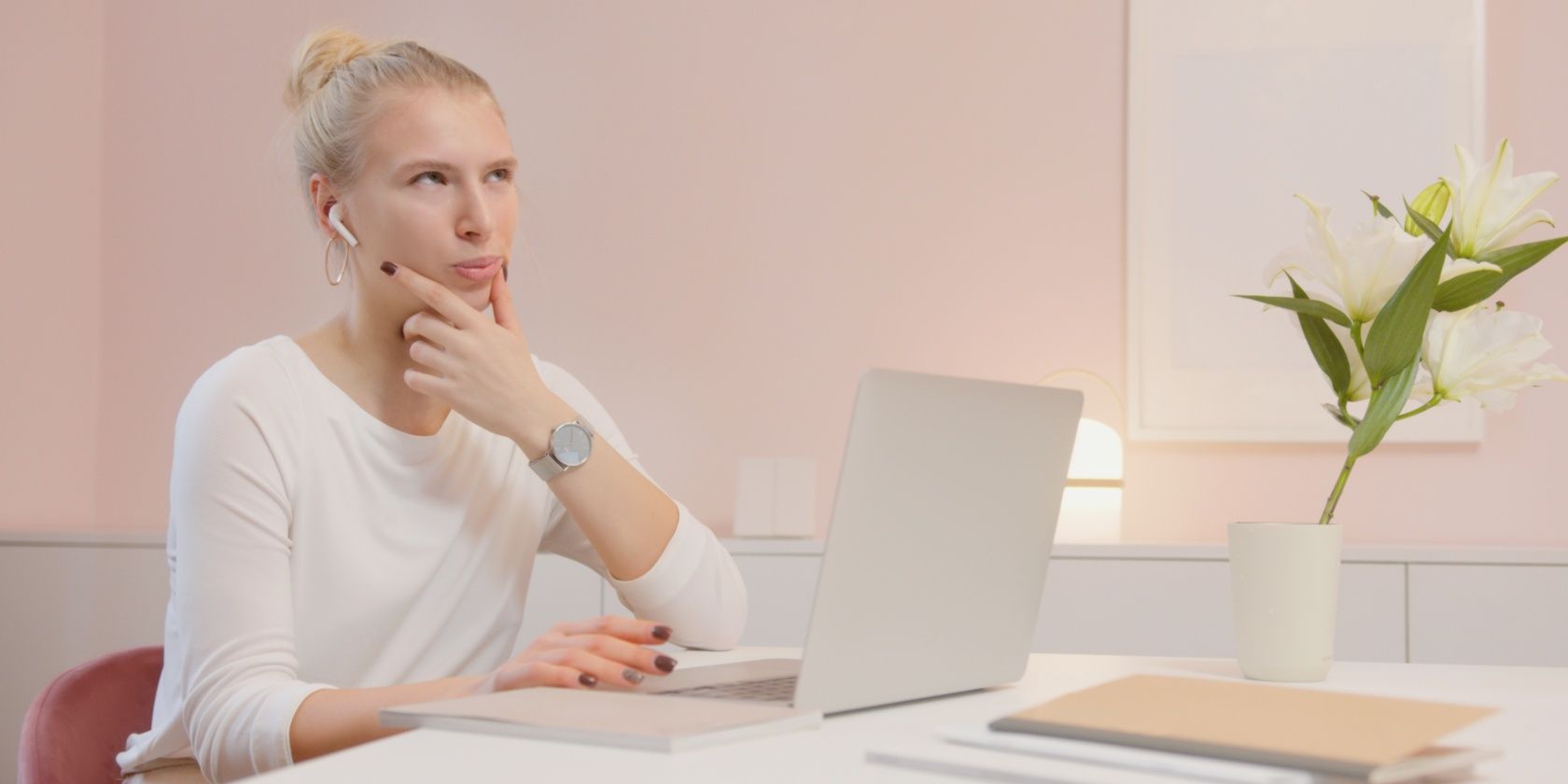 Woman sat at laptop and thinking