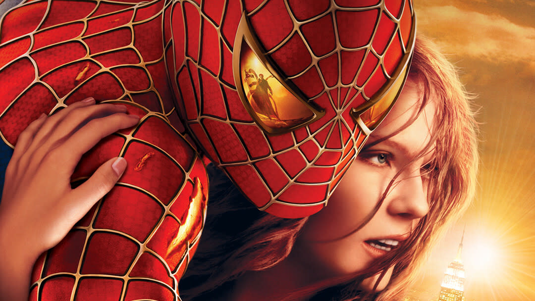 پوستر Spider-Man 2 که مری جین را نشان می دهد که به مرد عنکبوتی چسبیده است.  بازتاب Doc Ock را می توان در لنز چشمی لباس مرد عنکبوتی مشاهده کرد.