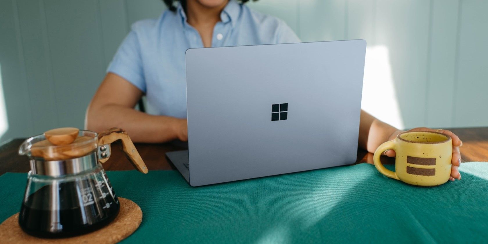 A woman working on a Windows laptop